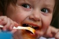 Young girl eating mush