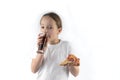 Young girl eating pizza and drinking an ice drink.