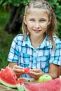 Young girl eating ripe watermelon