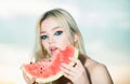 Young girl eating watermelon, summer tropical fruits. Beauty woman face.