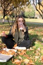 Young girl eats pizza in the park Royalty Free Stock Photo