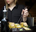 young girl eats sushi in a Japanese restaurant Royalty Free Stock Photo