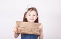 Young girl with empty board for inscription, white background