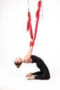 Young girl is engaged in fly yoga and stretching. Stretching and strengthening muscles. Aeroyoga.Copy space. Isolated