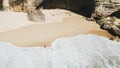 Young girl enjoying empty tropical beach in Bali. View over beach, stunning aerial view of a rocky shore with a beautiful beach ba Royalty Free Stock Photo