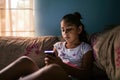 Young Girl Enjoying Leisure Time At Home Engrossed In Her Phone Royalty Free Stock Photo