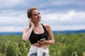 Young girl enjoying music in headphones. A girl in sportswear wearing headphones with a phone in her hands Royalty Free Stock Photo