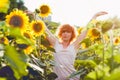 Young girl enjoying nature on the field of sunflowers at sunset, portrait of the beautiful redheaded woman girl with a sunflowers Royalty Free Stock Photo