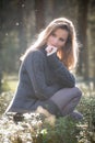 Young girl enjoying spring afternoon sun in the woods