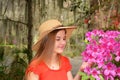 Young girl enjoying time in the beautiful blooming garden.