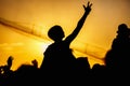 Young girl enjoys a rock concert, Silhouette on sunset Royalty Free Stock Photo