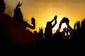Young girl enjoys a rock concert, Silhouette on sunset Royalty Free Stock Photo