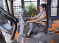 Young girl exercise bike cardio workout at fitness gym Royalty Free Stock Photo