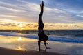 Young girl exercising on a seaside beach at sunset Royalty Free Stock Photo