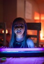 Young Girl with Face Paint Glowing Under Blacklight - Enchanting Halloween Glow