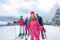 Girl with family on ski slope on vacation in mountain Royalty Free Stock Photo