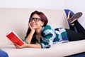 Young girl fantasizing while reading a book Royalty Free Stock Photo