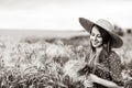 Farm girl holding wheat ears on a field Royalty Free Stock Photo