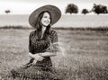 Farm girl holding wheat ears on a field Royalty Free Stock Photo