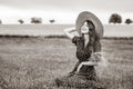 Farm girl holding wheat ears on a field Royalty Free Stock Photo