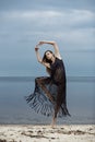 Young girl in a fashionable blue cape dancing on the background Royalty Free Stock Photo