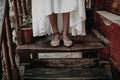 Young girl feet standing on the old wooden steps. Royalty Free Stock Photo