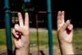 Young girl/females hands in the form of a hand gesture for peace.