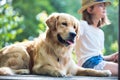 Young girl fishing while sitting with dog on pier Royalty Free Stock Photo