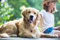 Young girl fishing while sitting with dog on pier Royalty Free Stock Photo