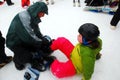 A young girl is fitted with a snow board