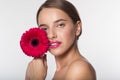 Young girl with flawless skin and red flower Royalty Free Stock Photo