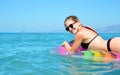 Young girl floating on inflatable mattress in the sea. Royalty Free Stock Photo
