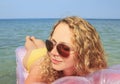 Young girl floating on a mattress in the sea Royalty Free Stock Photo