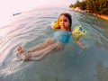 Young girl floating in shallow water Royalty Free Stock Photo