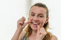 Young girl flossing her teeth Royalty Free Stock Photo