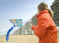 Young girl flying a kite on the beach Royalty Free Stock Photo