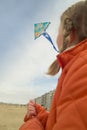 Young girl flying a kite on the beach Royalty Free Stock Photo