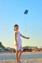 Young girl flying a kite on the beach Royalty Free Stock Photo