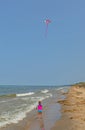 Young Girl Flying a Kite on the Beach Royalty Free Stock Photo