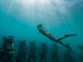 Freediving Girl swims over Underwater sculptures gili Meno, Southeast Asia