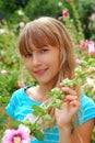 Young girl in the garden of mallows Royalty Free Stock Photo