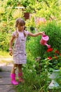 Young girl in the garden with watering can