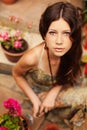 Young girl gardener with long brown hair holding a garden tool Royalty Free Stock Photo