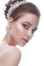 A young girl in a gentle wedding image with a diadem on her head. Beautiful model in the image of the bride on a white isolated ba Royalty Free Stock Photo