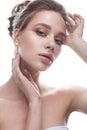 A young girl in a gentle wedding image with a diadem on her head. Beautiful model in the image of the bride on a white isolated ba