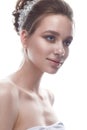 A young girl in a gentle wedding image with a diadem on her head. Beautiful model in the image of the bride on a white isolated ba Royalty Free Stock Photo