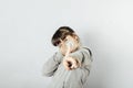 Young girl gesticulating and playing with a medical mask. White background Royalty Free Stock Photo