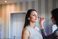 Young girl gets a beauty treatment by a professional makeup artist in her beauty parlour