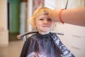 young girl gets a new haircut at a local beauty salon.