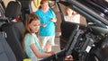 A young girl gets to sit in a police cruiser